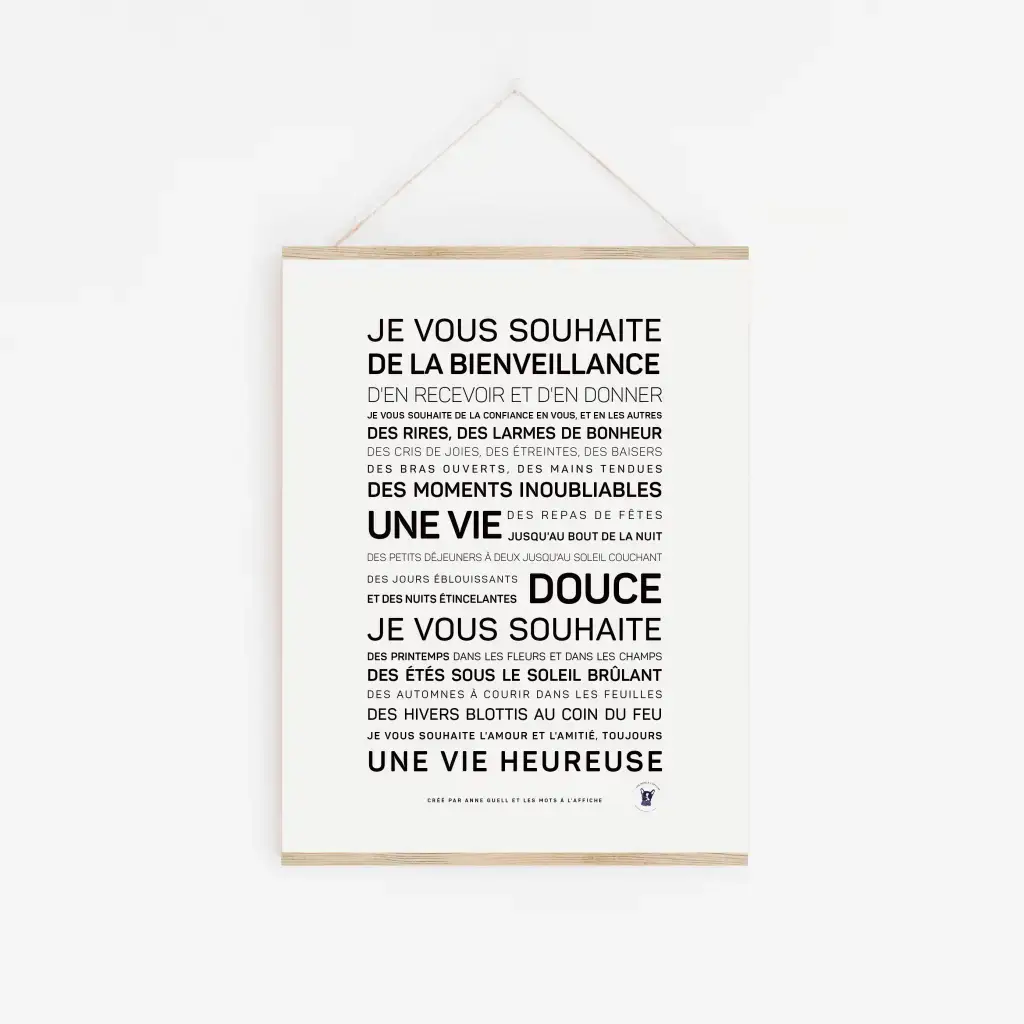 Une affiche blanche intitulée « De la bienveillance - Anne Guell » est accrochée au mur, affichant du texte français dans des polices variées avec des vœux encourageants de gentillesse, de bonheur, de moments inoubliables et d'une vie joyeuse - une idée cadeau inspirante.