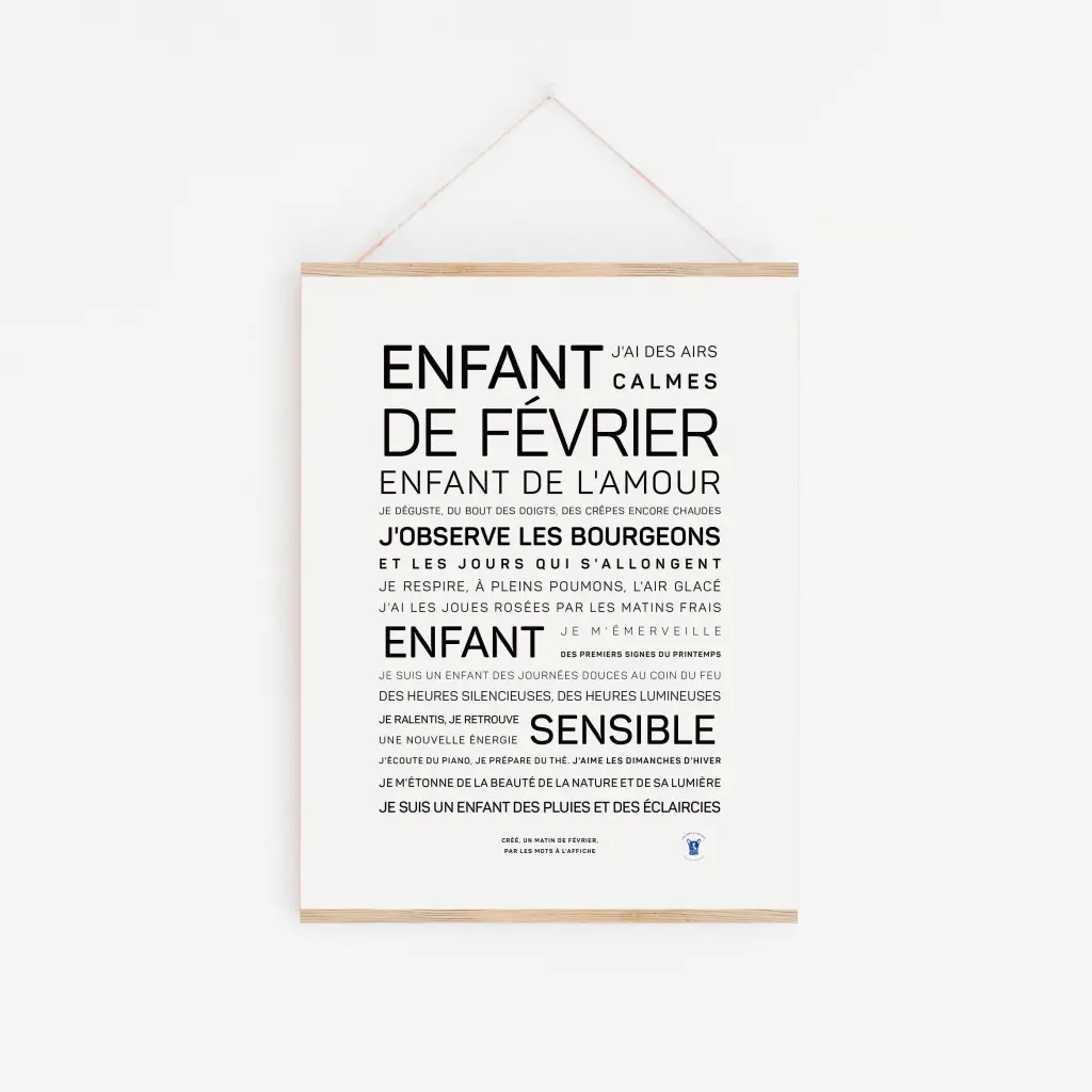 Une affiche minimaliste « Enfant de février » est accrochée sur un mur blanc, avec un texte français sur le fait d'être un enfant de février calme et sensible dans des polices variées - une idée cadeau originale pour toute occasion.