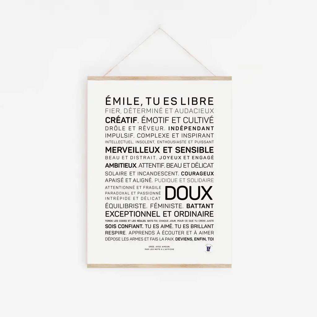 Une affiche minimaliste « Emile, tu es libre et doux » est accrochée sur un mur blanc, présentant des adjectifs et des phrases français inspirants en texte noir : une idée cadeau parfaite pour toute occasion.