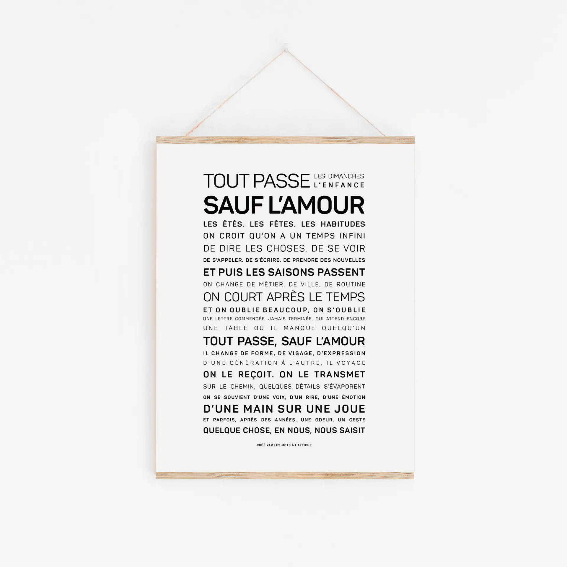 Une affiche blanche, sur laquelle figure en gros caractères noirs un texte en français intitulé « Dans cette école, on a le droit (Copie) », est accrochée à un cadre en bois sur un mur blanc.