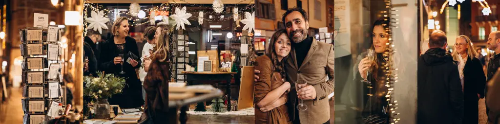 Les invités discutent à l'intérieur lors d'un événement à l'éclairage chaleureux, en admirant les décorations, en bavardant et en sirotant un verre. Certains se tiennent près des décorations et des cartes, tandis que d'autres prennent la pose pour une photo et sourient.